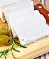 Feta with olives on a brown cloth