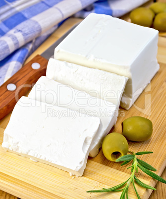 Feta with olives on board with blue cloth