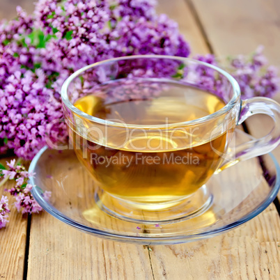 Herbal tea of oregano on board in glass cup