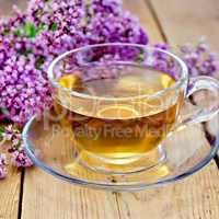 Herbal tea of oregano on board in glass cup