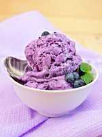 Ice cream blueberry with spoon on napkin