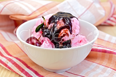 Ice cream cherry with chocolate syrup on napkin