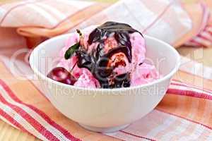 Ice cream cherry with chocolate syrup on napkin