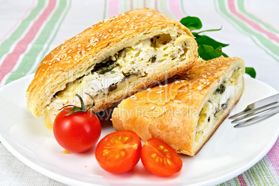 Roll filled with spinach and cheese in bowl on tablecloth