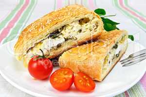 Roll filled with spinach and cheese in bowl on tablecloth