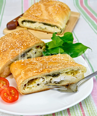 Roll filled with spinach and cheese on tablecloth