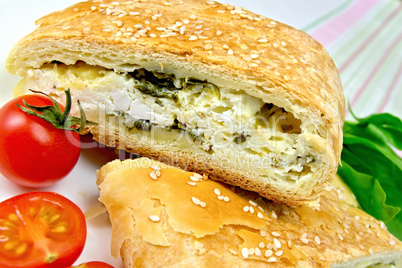 Roll filled with spinach and cheese on linen tablecloth