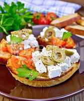 Sandwich with feta and olives on board