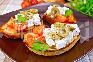 Sandwich with feta and olives on tablecloth