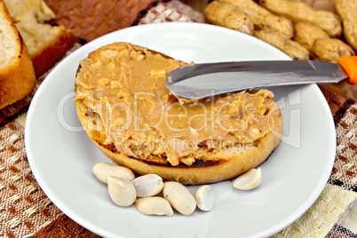 Sandwich with peanut butter and knife on napkin
