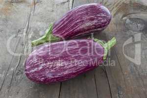 Two Aubergines on wooden board