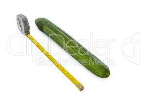 cucumber with measuring tape on white
