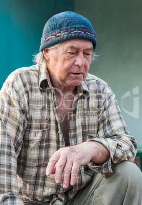 Seniors portrait of contemplative old caucasian man looking down