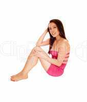 Asian woman sitting on floor.