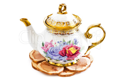 Ceramic teapot on Wooden stand .