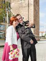Bride and groom makes selfie before monument