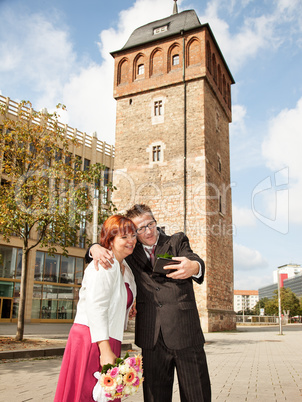 Bride and groom makes selfie before monument