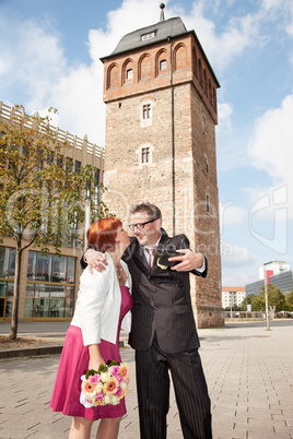 Bride and groom makes selfie before monument