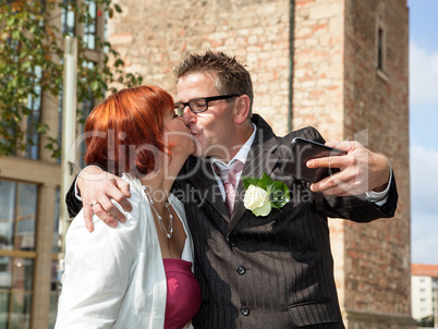 Bride and groom makes selfie before monument