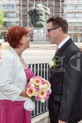 Bride and groom in front of Karl-Marx-Monument