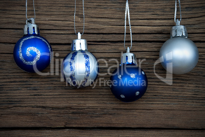 Four Decorated Christmas Balls on Wood