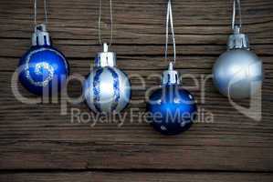 Four Decorated Christmas Balls on Wood