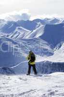 Snowboarder on top of off-piste slope