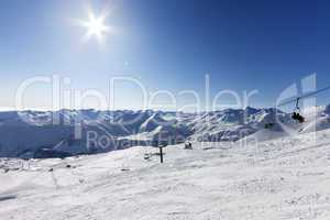 Ski slope and sky with sun