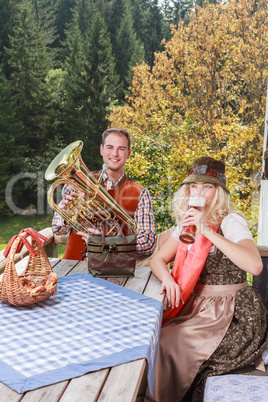 Junges Paar in traditioneller bayerischer Kleidung beim gemeinsamen geniessen Ihrer Freizeit