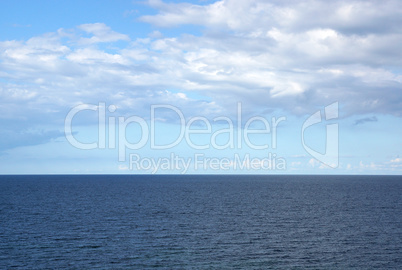 Ocean with blue sky and summer clouds