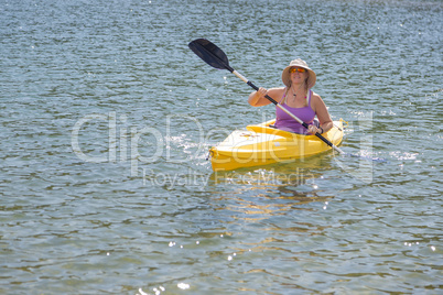 Woman Kayaking on Beautiful Mountain Lake.