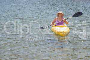 Woman Kayaking on Beautiful Mountain Lake.