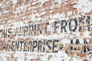 Old Weathered Brick Wall with Advertisement