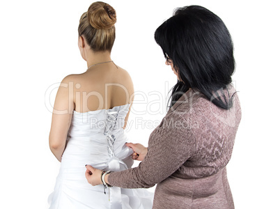 Photo of bridesmade and bride in dress from back