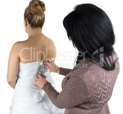 Image of bridesmade and bride in dress from back