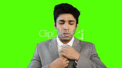 Young businessman adjusting his tie