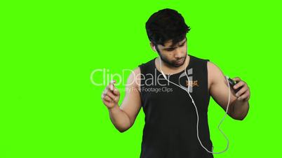 Young man listening to music on cell phone