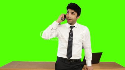 Young businessman talking on mobile phone