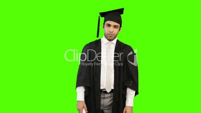 Man in graduation gown holding a diploma