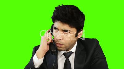 Businessman talking on telephone and showing thumbs up