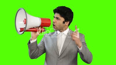 Young businessman talking into a megaphone