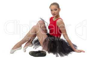 Photo of ballerina sitting on the floor