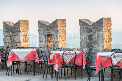 Prepared outdoor tables on a ancient medieval terrace