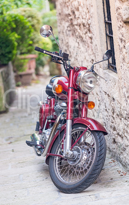 Colourful motorbike parked on a narrow medieval street