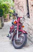 Colourful motorbike parked on a narrow medieval street