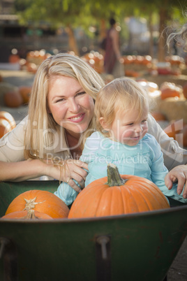 Young Mother and Daughter Enjoys the Pumpkin Patch