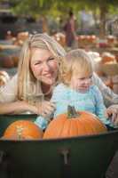 Young Mother and Daughter Enjoys the Pumpkin Patch