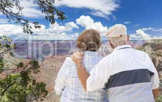 Happy Senior Couple Looking Out Over The Grand Canyon