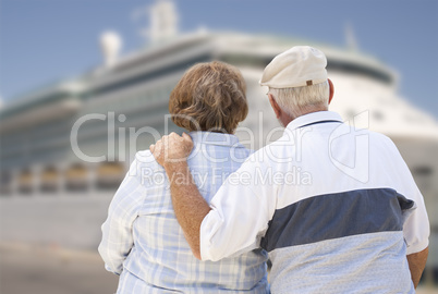 Senior Couple On Shore Looking at Cruise Ship