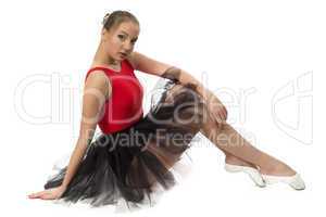 Photo of young ballerina sitting on the floor